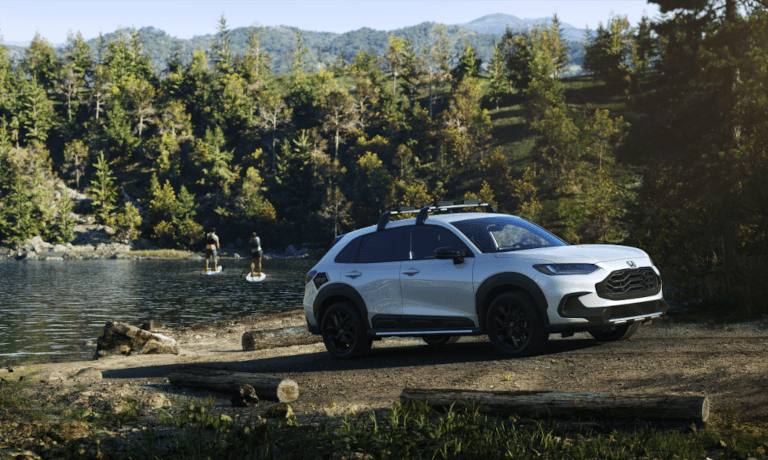 2023 Honda HR-V parked by a lake with paddleboarders